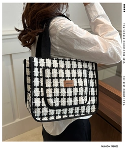 Detail of checkered tote bag with JINGPIN logo and thick textured fabric strap