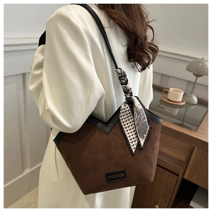 Brown frosted tote bag with black V-shaped leather trim and silk scarf on the shoulder strap