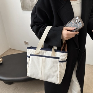 Minimalist corduroy tote bag in white and navy blue with wide fabric shoulder strap