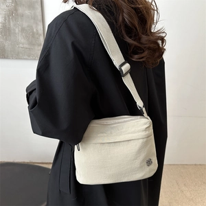 Minimalist cream white crossbody bag with nylon fabric and metal flower logo for women