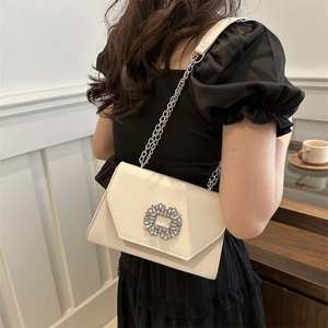 Chic cream white crossbody bag with sparkling rhinestone buckle and silver chain strap