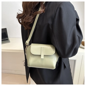 Adjustable pistachio green crossbody bag for women shown in a modern office lifestyle setting