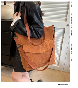 Detail of caramel brown corduroy tote with dual straps and large front flap pocket