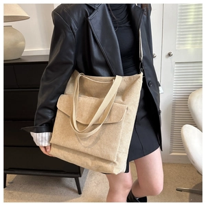 Dettaglio della borsa tote in velluto a coste beige con tasca frontale e tracolla