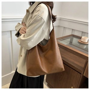 Close-up of caramel brown hobo bag showing pebbled leather texture and large capacity