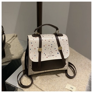 Detail of retro mini backpack with colorful dots and Aimity 1986 logo branding