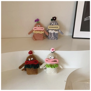 Detail of four handmade crochet doll pouches with big lips and colorful knitted textures
