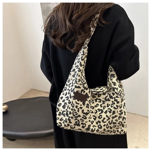 Detail of leopard print tote bag with corduroy texture and fashion leather patch