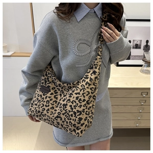 Close-up of leopard print corduroy tote bag featuring a leather FASHION label