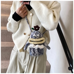 Detailed knit texture of handmade cartoon doll crossbody bag with floral detail