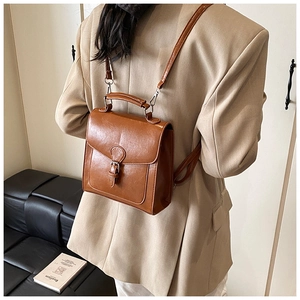 Brown vintage faux leather backpack on model showing casual size and styling for daily use