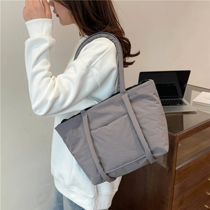 Grey quilted puffer tote bag with large front pocket for women stylish commuter shoulder bag