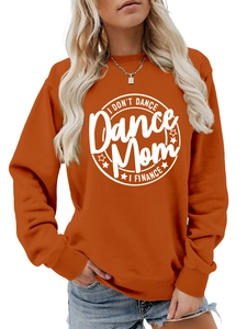 Close-up of I Don't Dance text print on burnt orange crewneck sweatshirt fabric