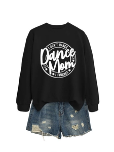Detail of the letter print on black crewneck sweatshirt paired with distressed denim shorts