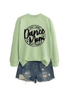 Detail of light green sweatshirt with I DON'T DANCE print and distressed denim shorts