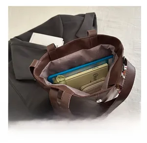 Interior view of brown faux leather tote bag showing large capacity for tablet and wallet