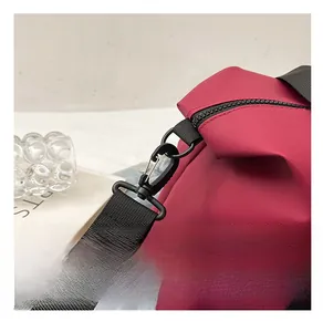 Close-up of black matte metal hook and durable nylon strap on a waterproof bag