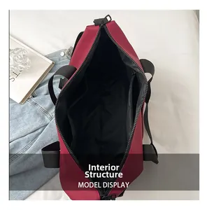 Internal structure of large waterproof travel bag showing dark lining and zip pocket