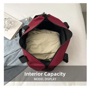 Spacious interior view of the burgundy waterproof travel bag showing large storage capacity