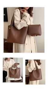 Detail of a brown large capacity tote bag and matching zipper pouch set with charm