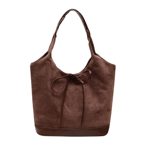 Brown suede tote bag with leather bow accent and spacious design for women fashion