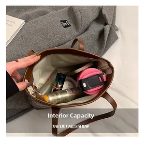 Overhead view showing large interior capacity of brown leather tote with daily essentials