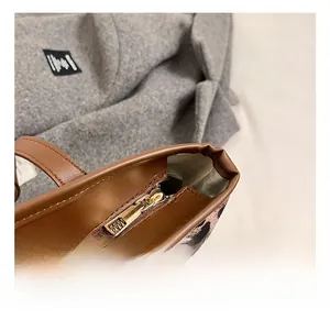 Detail of premium gold metal zipper and leather trim on vintage leopard tote bag