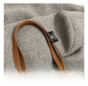 Detail of leopard print tote bag featuring brown faux leather handle and inner logo label