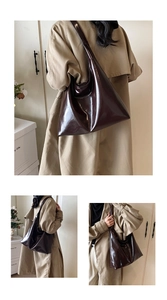 Detailed view of glossy dark brown patent leather tote bag styled with a trench coat