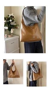 Detail view of large capacity camel patent leather tote bag with glossy finish and soft structure