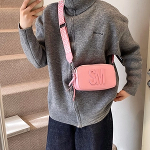 Pink rectangular leather crossbody bag with wide shoulder strap and SM letter detail