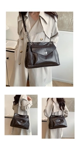 Detail of vintage brown leather crossbody bag with silver metal lock and chain strap