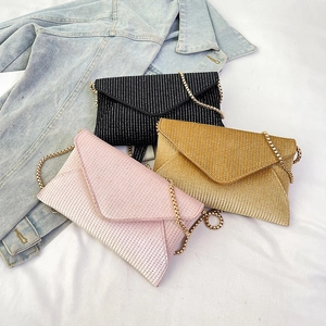 Sparkling envelope clutch bags in black, gold, and pink with rhinestone finish
