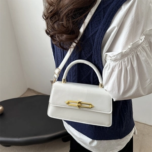 Chic white leatherette crossbody bag with gold buckle shown on a stylish model