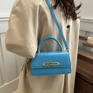 Chic blue leather crossbody bag with gold chain buckle and top handle for women