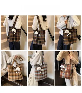 Detail of plaid tote bag featuring thick tweed fabric and a cute cloud plush charm
