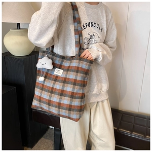 Retro plaid canvas tote bag with HOU brand label and plush cloud pendant detail