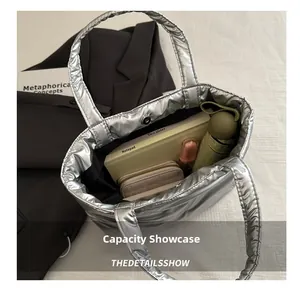 Silver padded tote bag capacity display showing notepad, wallet and essentials inside