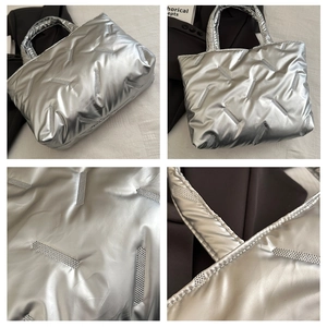 Detail view of silver quilted tote bag with metallic finish and puffy padded texture