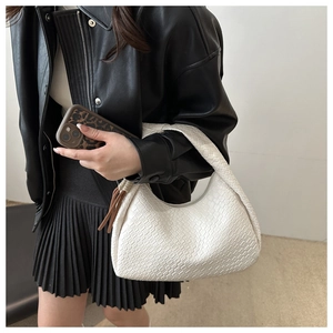 White woven texture hobo bag showing the woven leather detail and minimalist half-moon shape