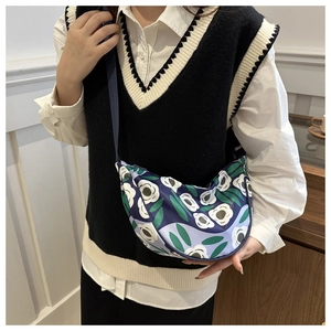Detail of floral dumpling bag with adjustable strap and durable navy fabric print