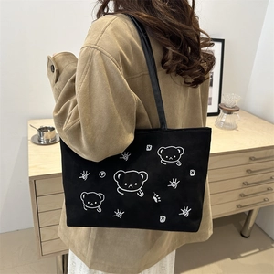 Japanese style black canvas tote bag with embroidered white bear design and long straps