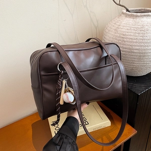 Deep brown faux leather shoulder bag with a vintage baseball charm for women
