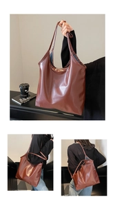 Macro detail of the dark brown PU leather tote bag featuring a glossy texture and minimal seams