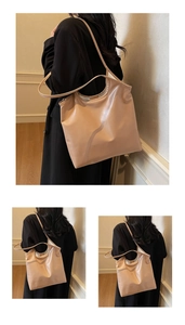 Close-up of light brown large capacity faux leather tote bag with long shoulder straps