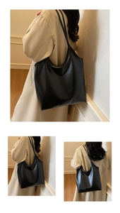Close-up of large black tote bag with glossy finish and durable shoulder strap for daily work