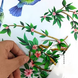 Detail of hummingbird and floral static window cling showing double-sided color patterns