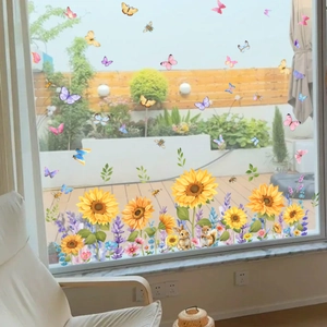 Detail view of sunflower and cute animal static window decals on a glass surface