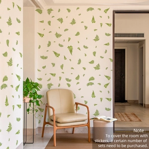 Détail de stickers muraux feuilles de fougère verte peintes à la main dans un salon moderne