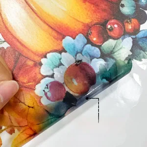 Detail of double-sided autumn pumpkin window sticker showing adhesive backing and transparency